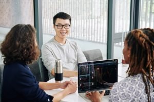 Man meeting with stock market traiders
