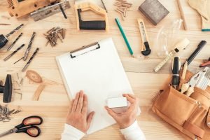 Self employed female carpenter is stamping project documentation