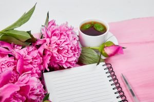 Beautiful pink peony flowers with note.