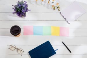 Message at colorful note papers on a desk background.