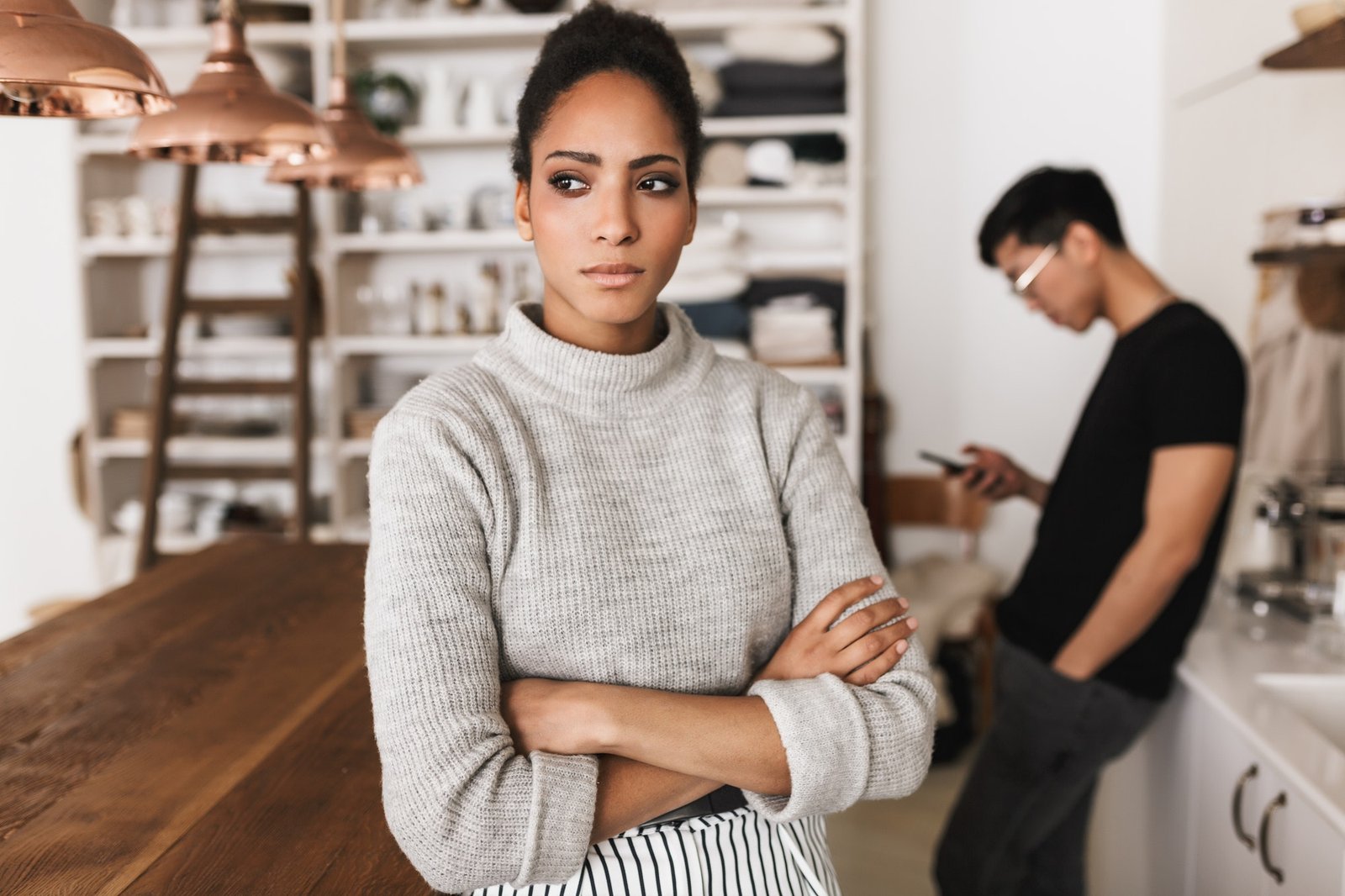 Young international couple in quarrel spending time on kitchen at home