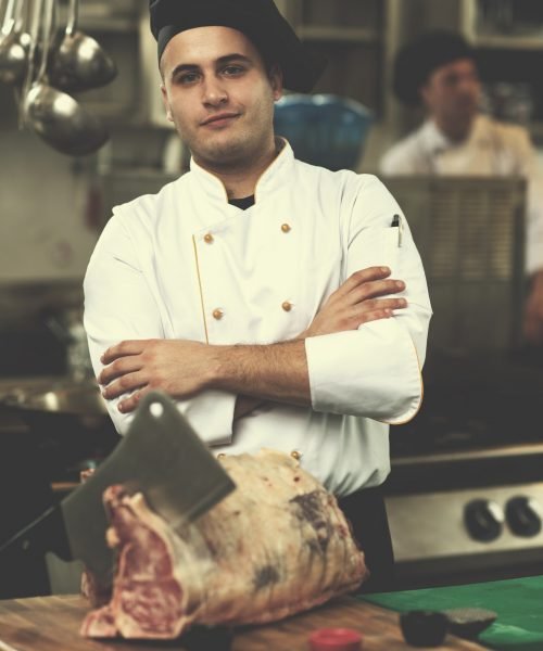 chef cutting big piece of beef chef cutting big piece of beef