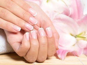 Beautiful woman's nails with french manicure