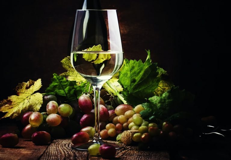 Dry white wine in glass, rustic still life