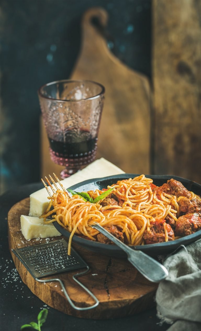 Italian pasta dinner with spaghetti, meatballs and red wine