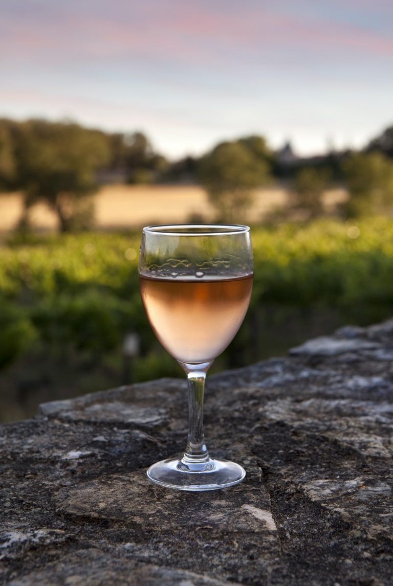 Rose wine glass on a stone wall