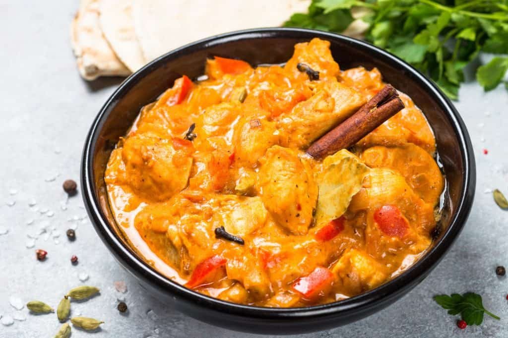 Chicken tikka masala with rice on black top view