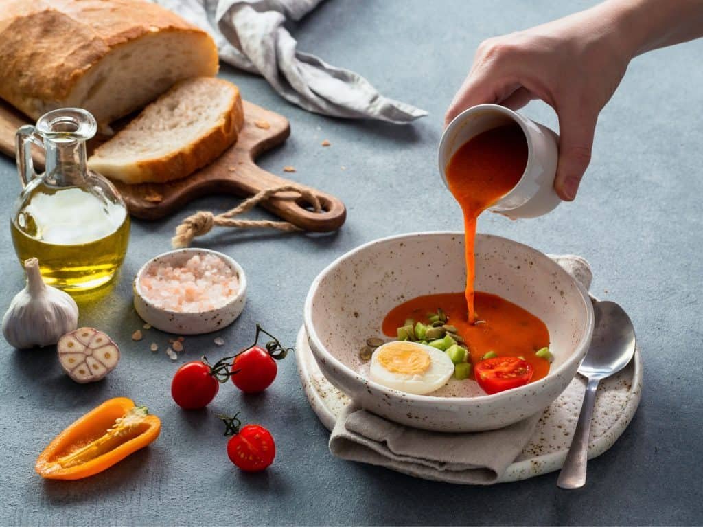 Hand pouring of Gaspacho soup