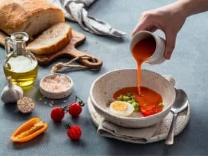 Hand pouring of Gaspacho soup