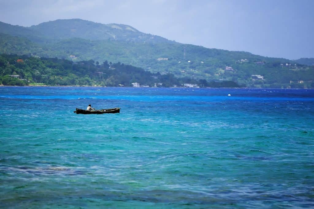 Silhouette of fisherman at stormz sea. Montego bay beach, Jamaica