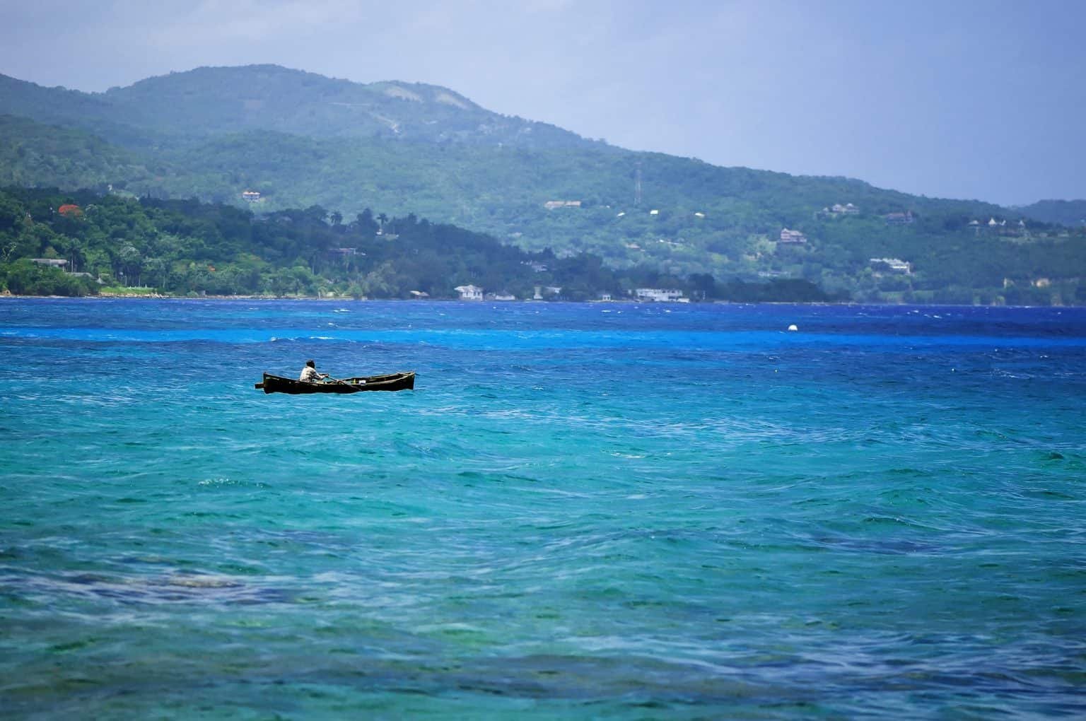 Silhouette of fisherman at stormz sea. Montego bay beach, Jamaica