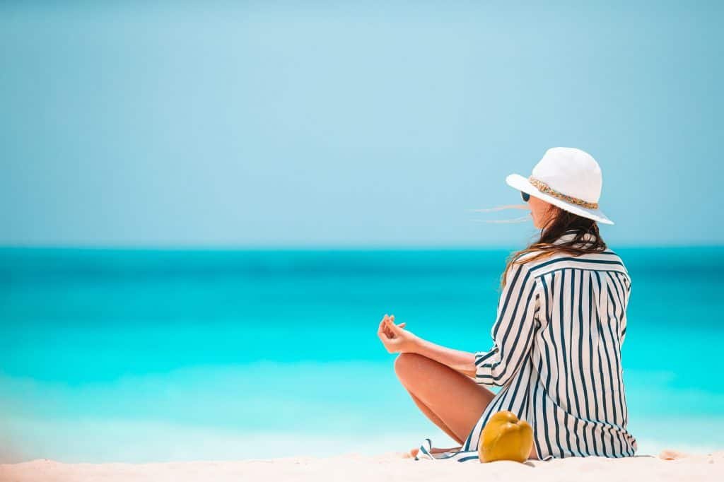 Body of beautiful woman in a meditation on the beach