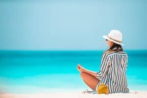 Body of beautiful woman in a meditation on the beach