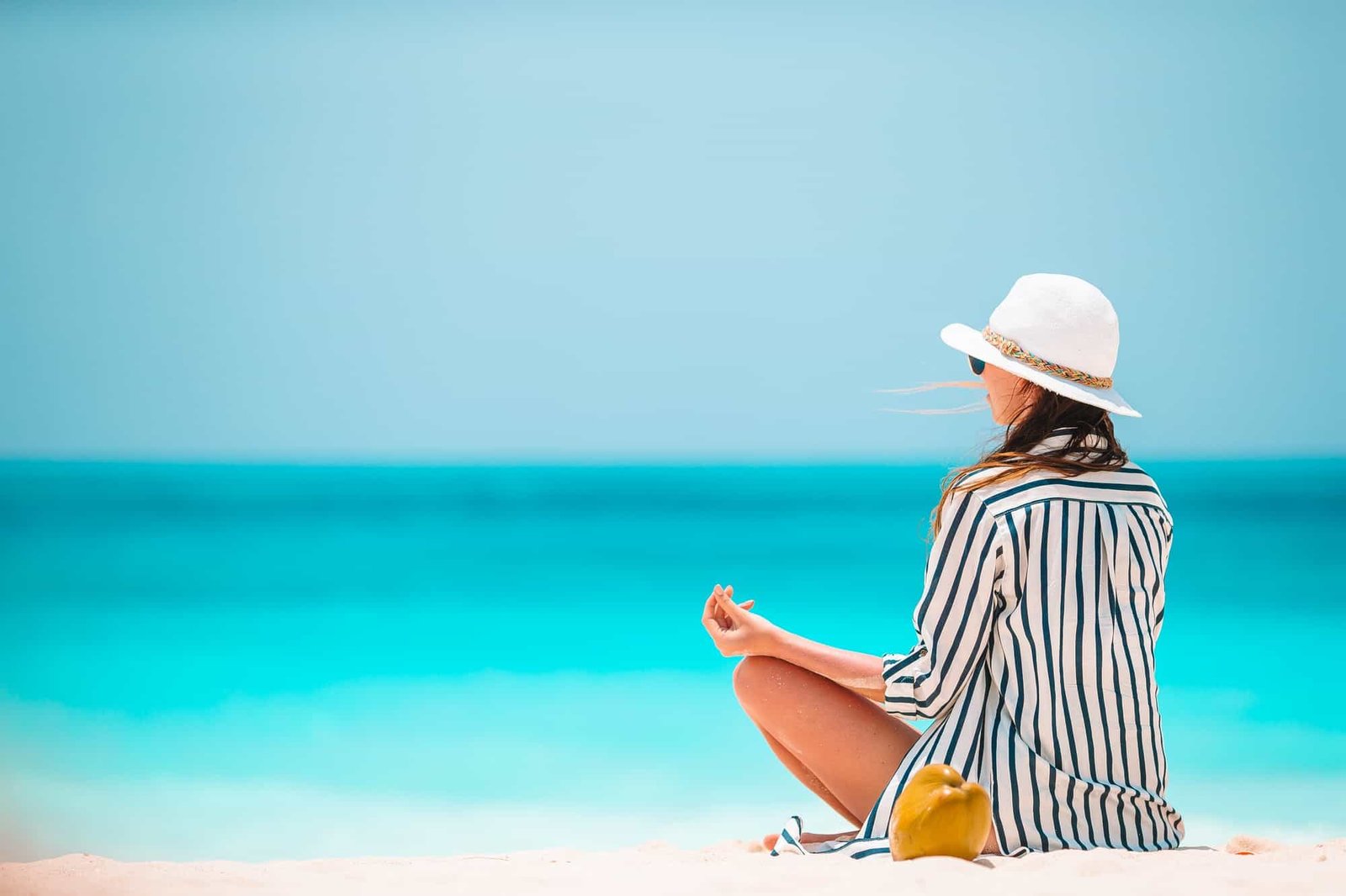 Body of beautiful woman in a meditation on the beach