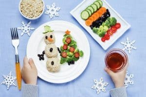children's hands with Christmas lunch with healthy food