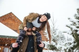 Couple having fun and laughing in winter