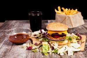 Delicious burger on wooden plate