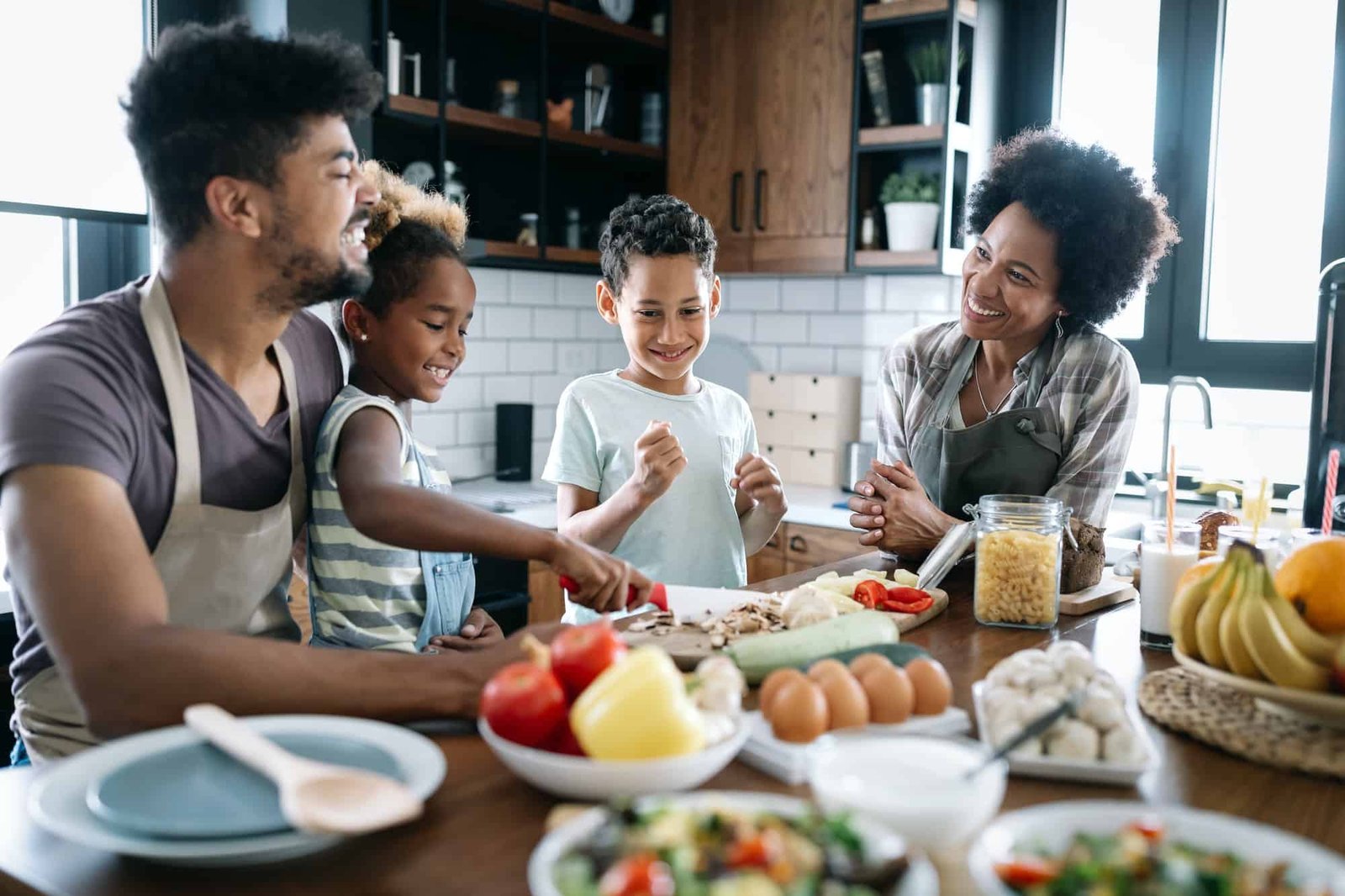 Happy family in the kitchen having fun and cooking together. Healthy food at home