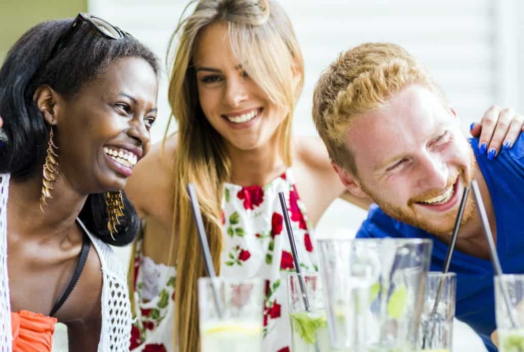 Happy young people laughing a being happy at a table