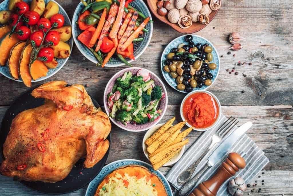 Thanksgiving dinner cooking preparation. Traditional dishes: chicken, pumpkin, corn, vegetables