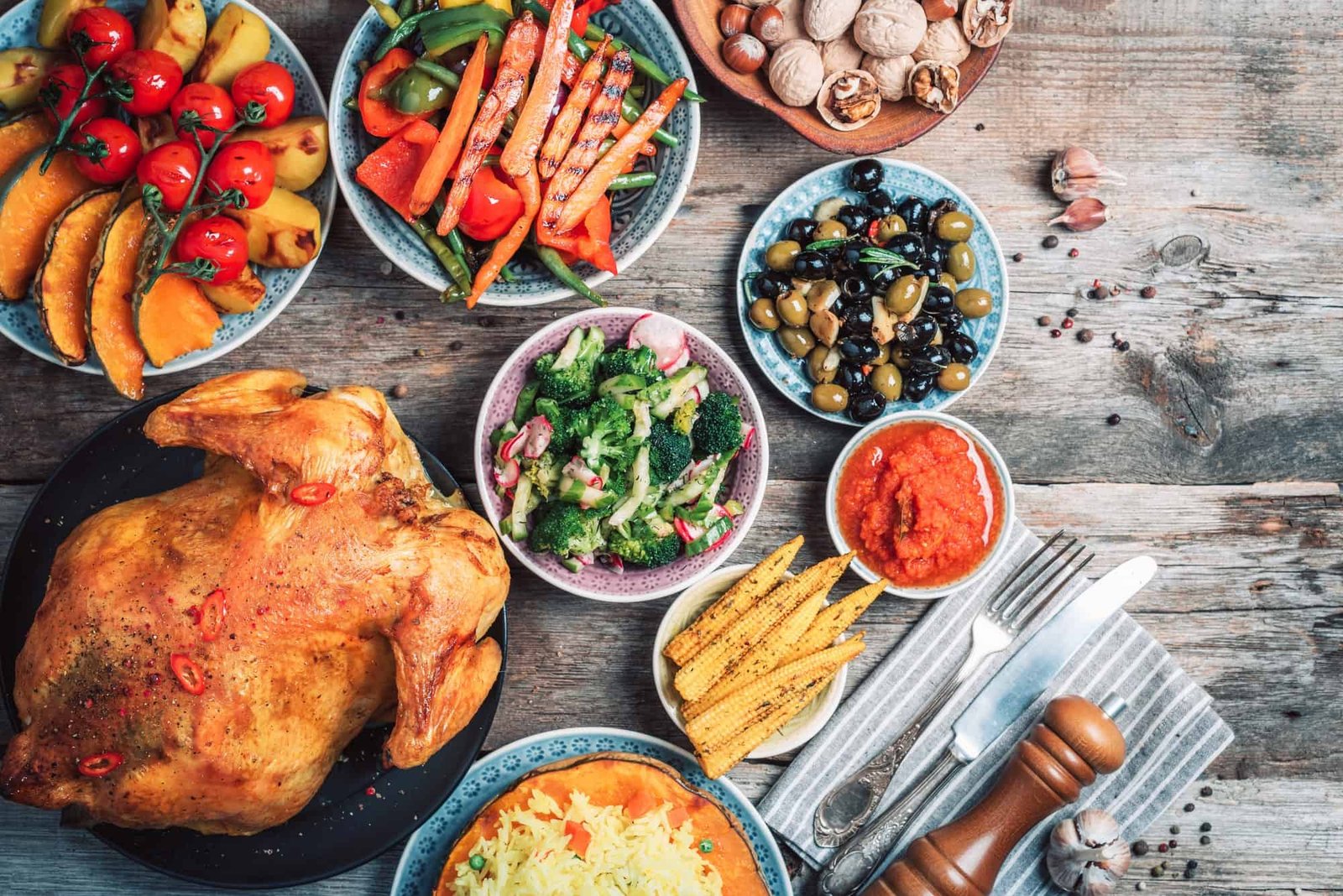 Thanksgiving dinner cooking preparation. Traditional dishes: chicken, pumpkin, corn, vegetables