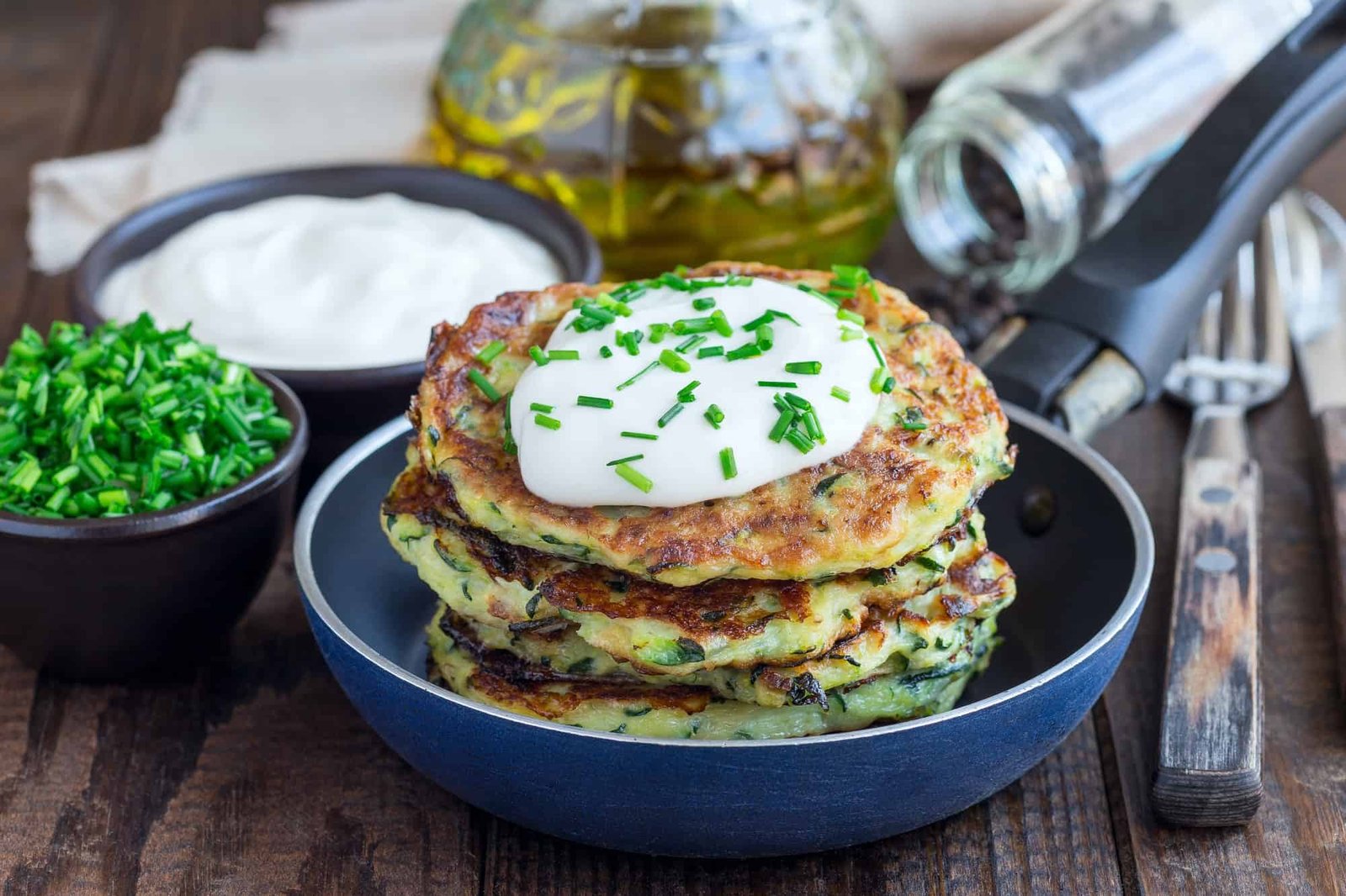 Vegetarian zucchini fritters or pancakes, served with greek yogu