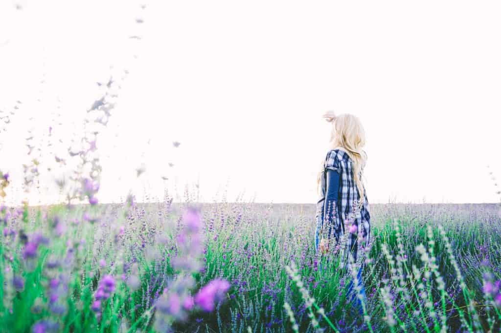 Young blonde woman alone in a lavender field