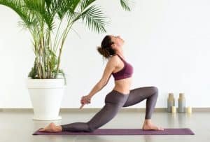 Young woman doing a low lunge yoga exercise