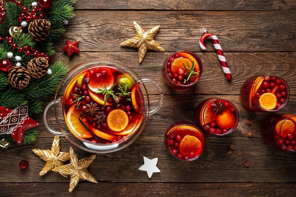 Christmas punch. Festive red hot toddy cocktail, drink with cranberries and citrus fruits