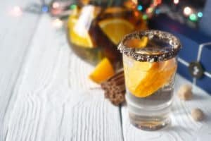 Citrus cocktail in the decorated glass on the white wooden table