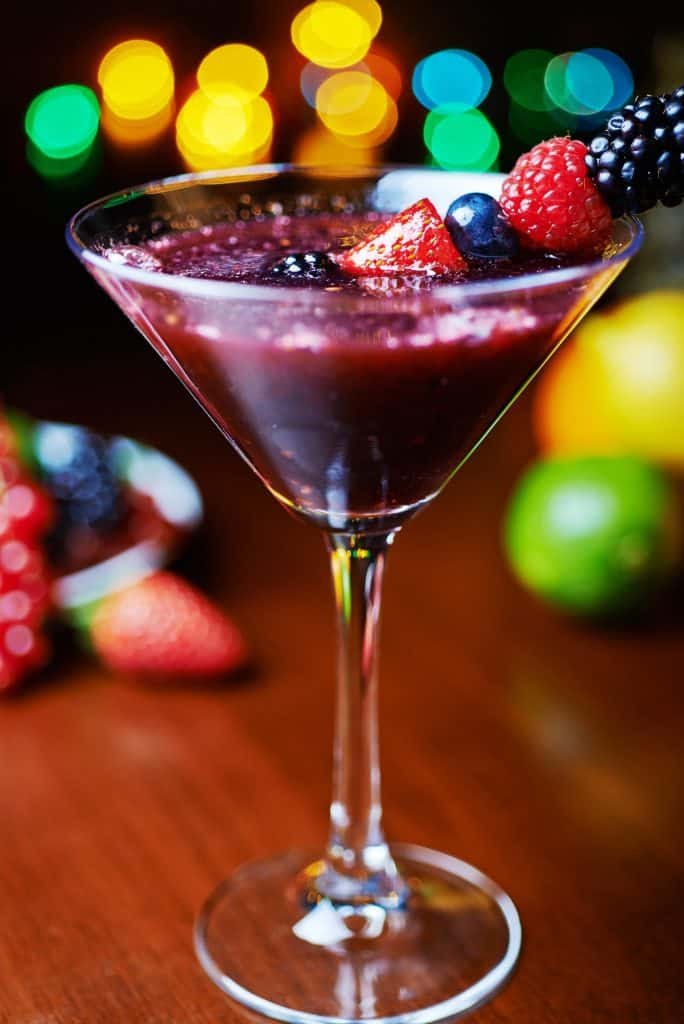 glass of tasty tropical cocktail with berries or lemonade.
