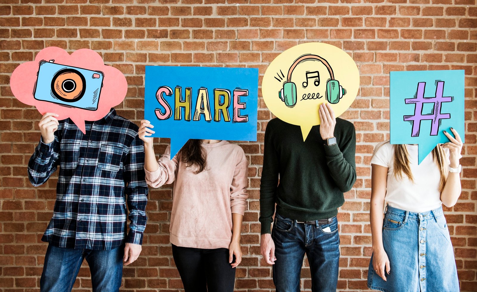Friends holding up thought bubbles with social media concept ico