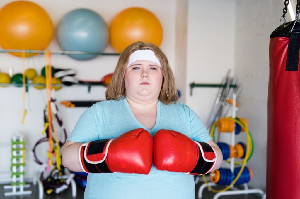 Overweight Woman Boxing in Gym