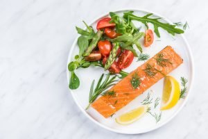 Serving cold smoked salmon fish, restaurant dish on plate