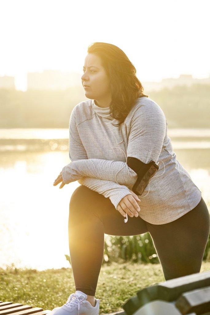 Young woman stretching before exercise
