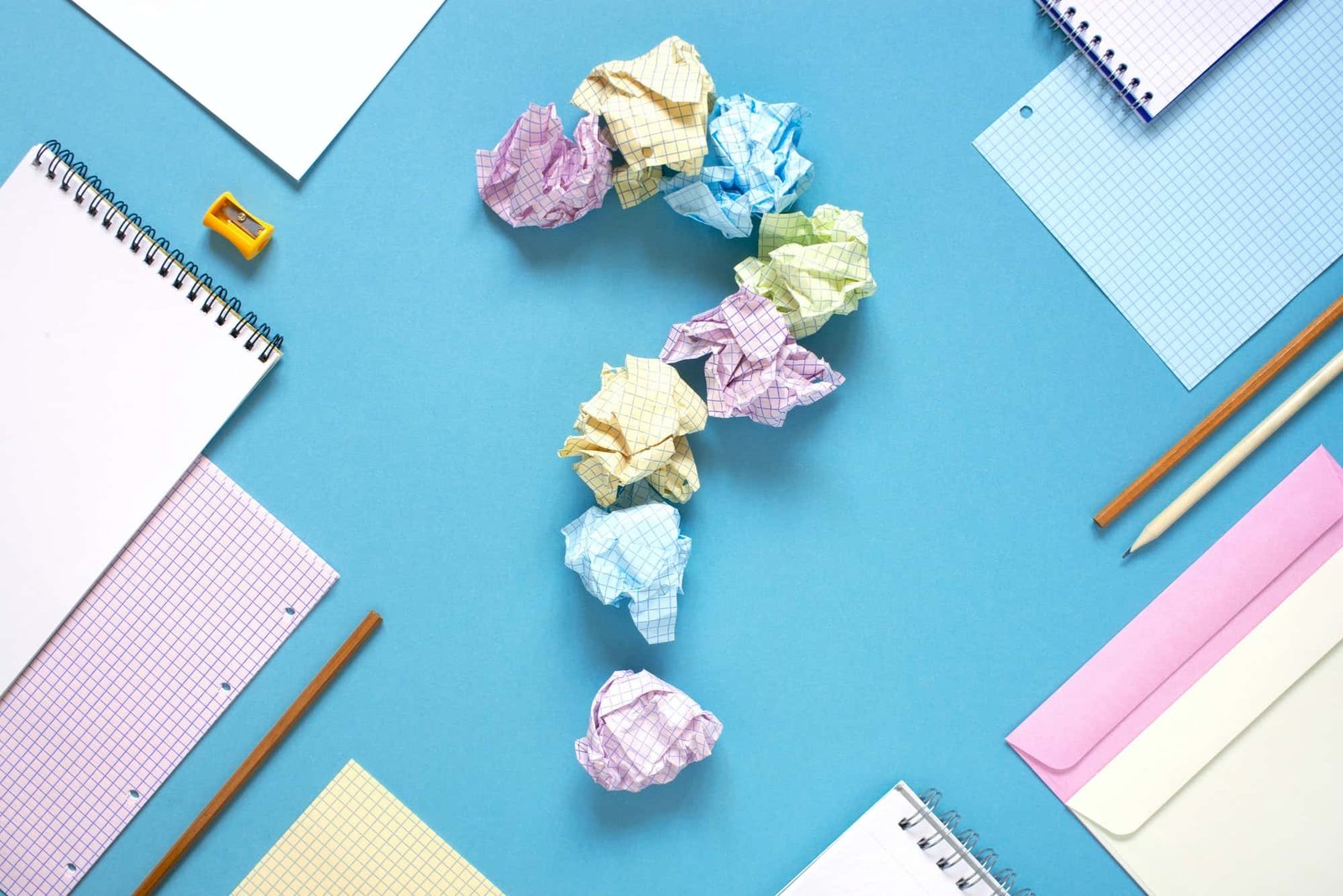 Blue Workplace with Notepads and Crumpled Sheets of Paper