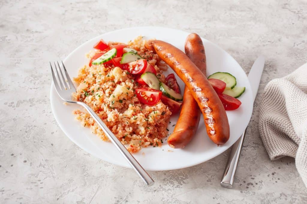 ketogenic paleo diet lunch. cauliflower rice and grilled sausages
