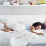 Black Woman Sleeping Alone in Large Bed