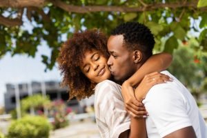 Outdoor protrait of black african american couple kissing each o