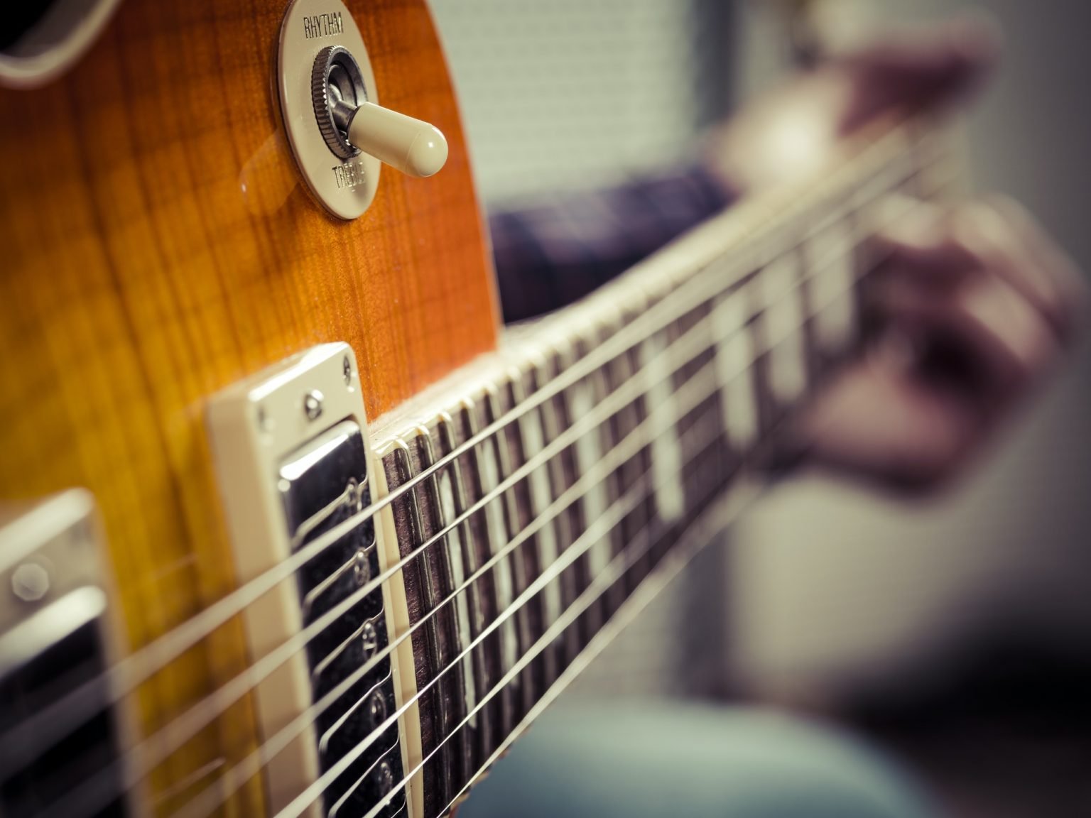 Closeup of guitarist playing electric guitar