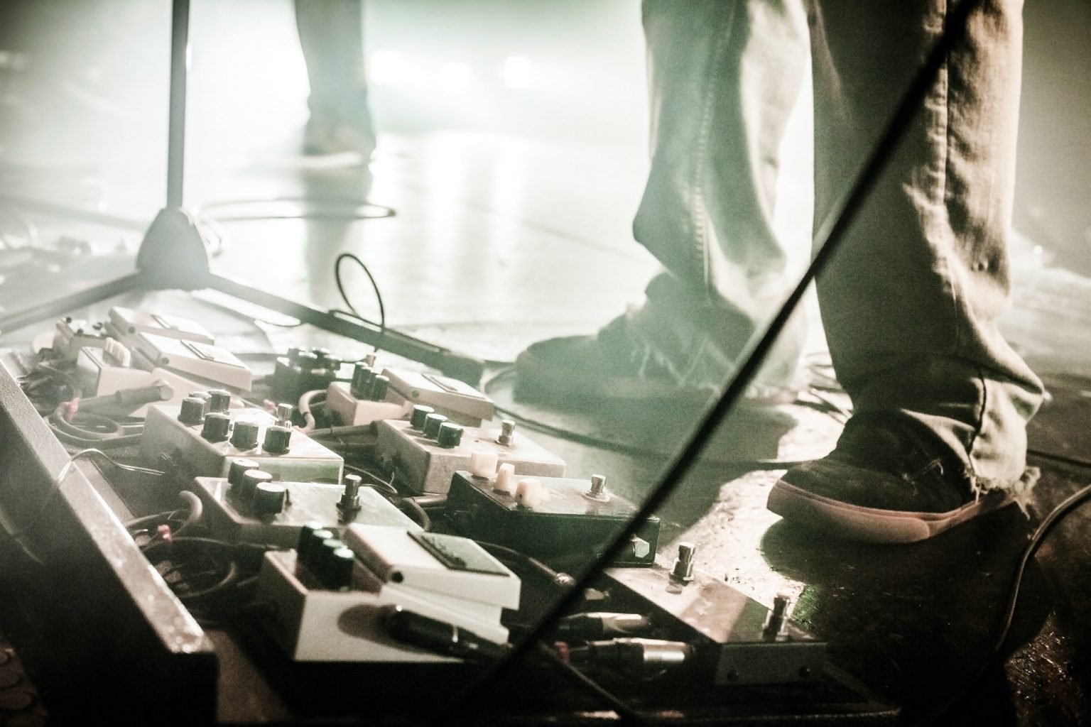 Guitar Pedals on a stage with live band performing during a Show