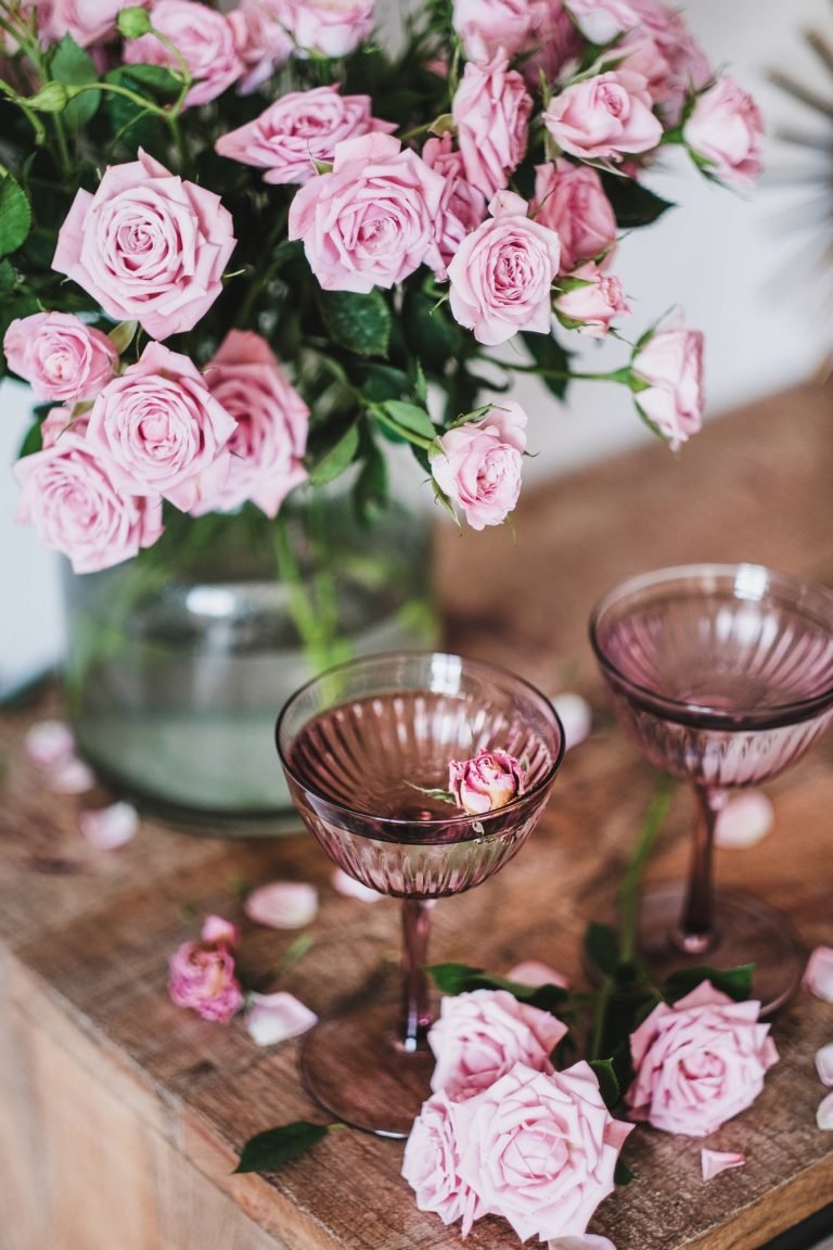 Valentines day greeting card with champagne and pink roses bouquet