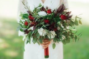 wedding bouquet of red flowers and greenery