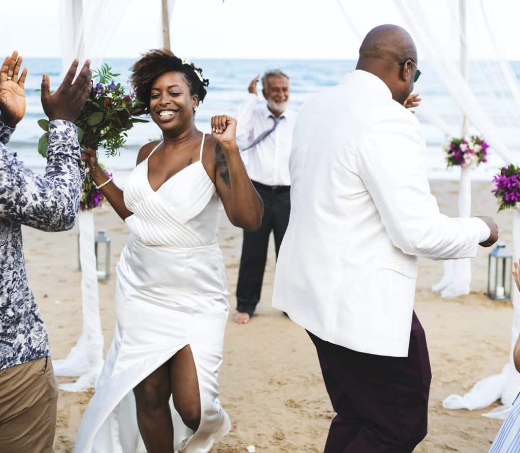 African American couple getting married at the beach