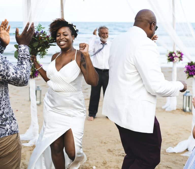 African American couple getting married at the beach