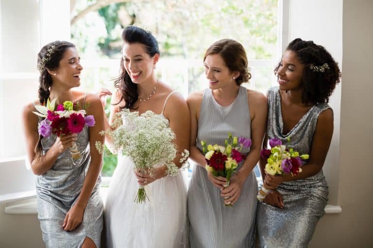 Bride and bridesmaids standing with bouquet