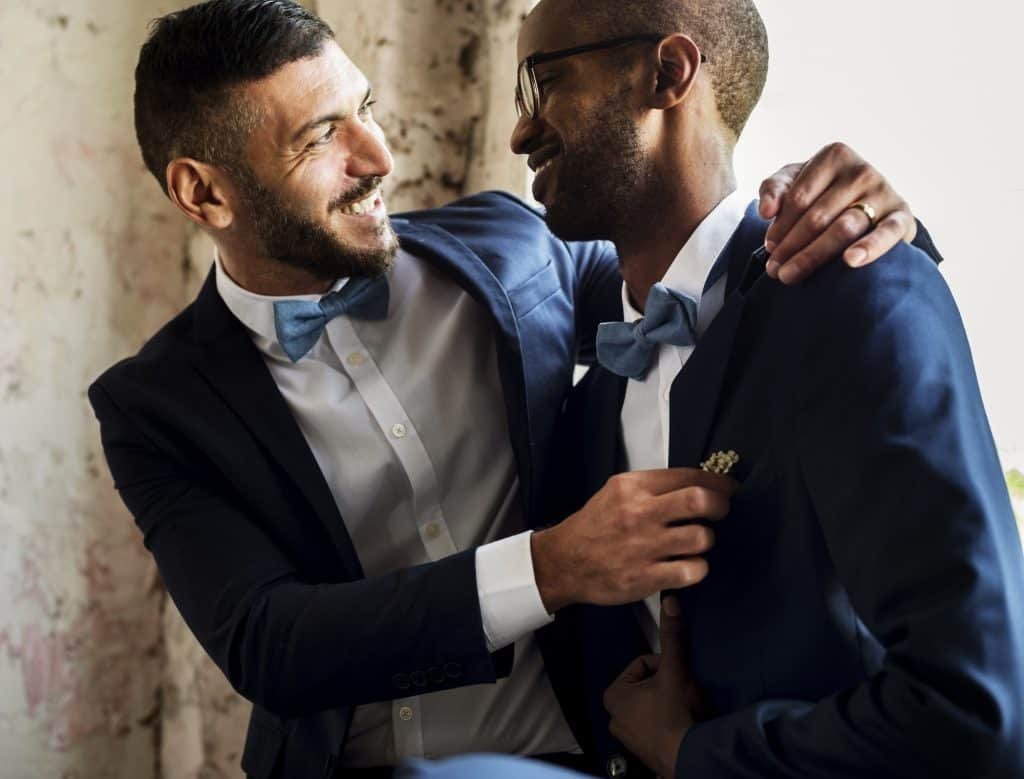 Gay Couple in Navy Blue Tuxedo Sitting Together