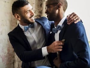 Gay Couple in Navy Blue Tuxedo Sitting Together
